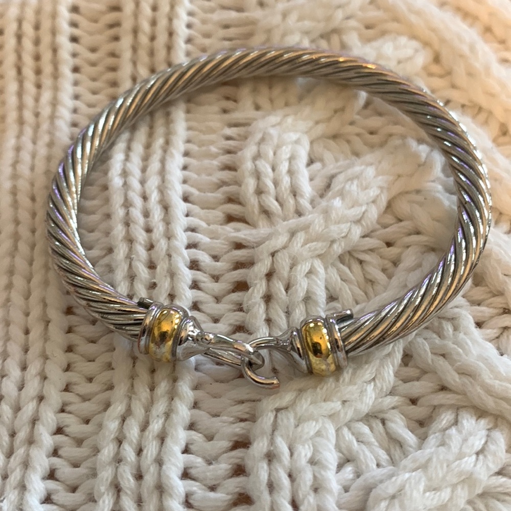Gold and Silver tone bracelet with clasp closure.